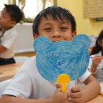 Student showing his picture at drawing class