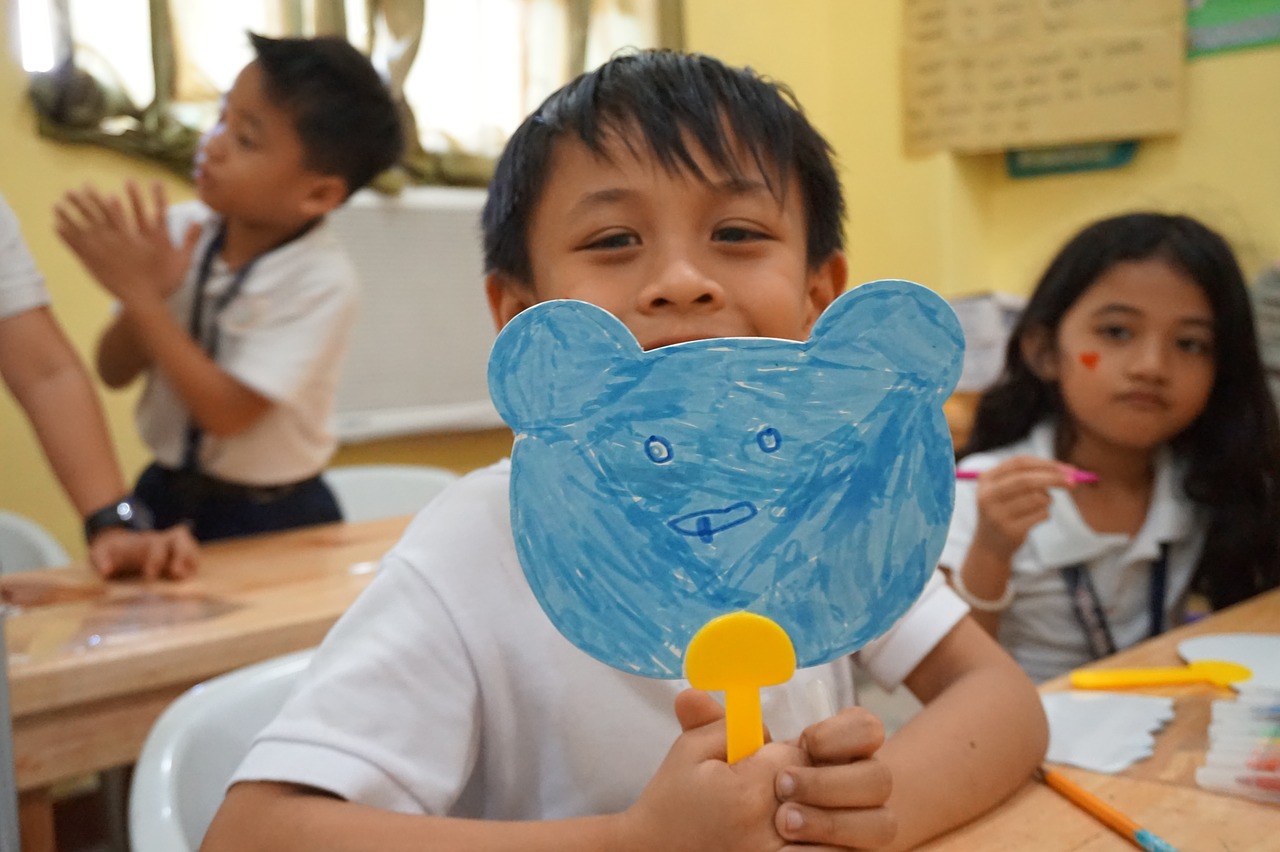 Student showing his picture at drawing class